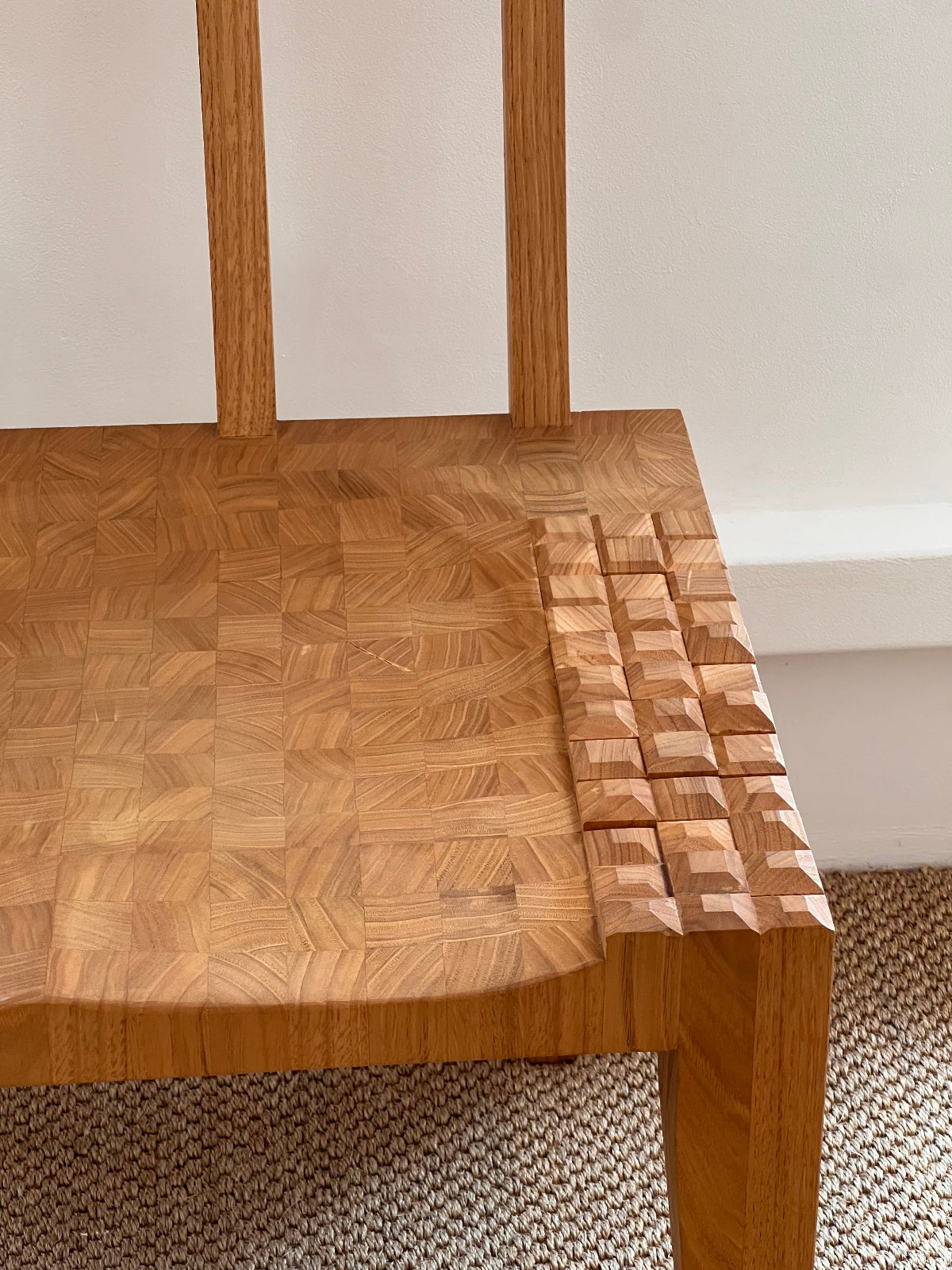 The facet chair by Rachel Glinsman featuring geometric carving and endgrain detail.