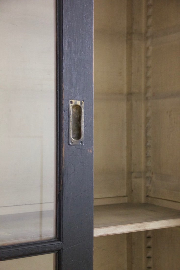 An ebonised sliding door cabinet