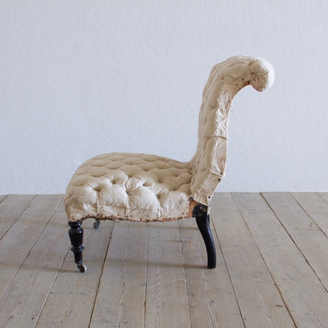 A buttoned slipper chair