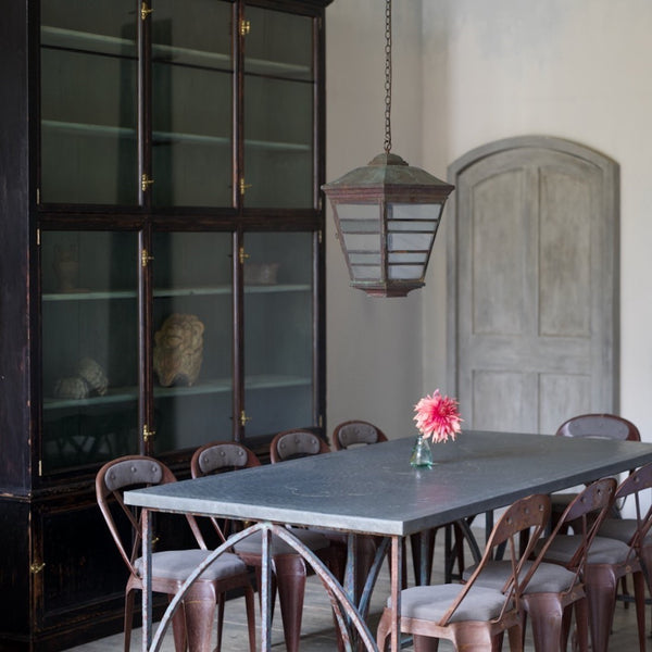 An architectural iron and zinc dining table