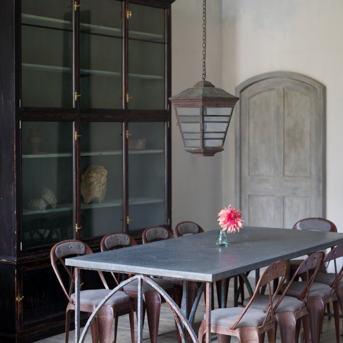 An architectural iron and zinc dining table