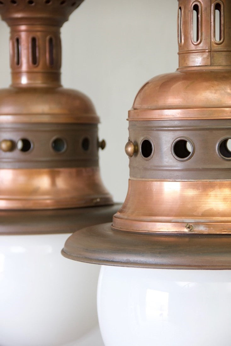 A pair of large copper pendants