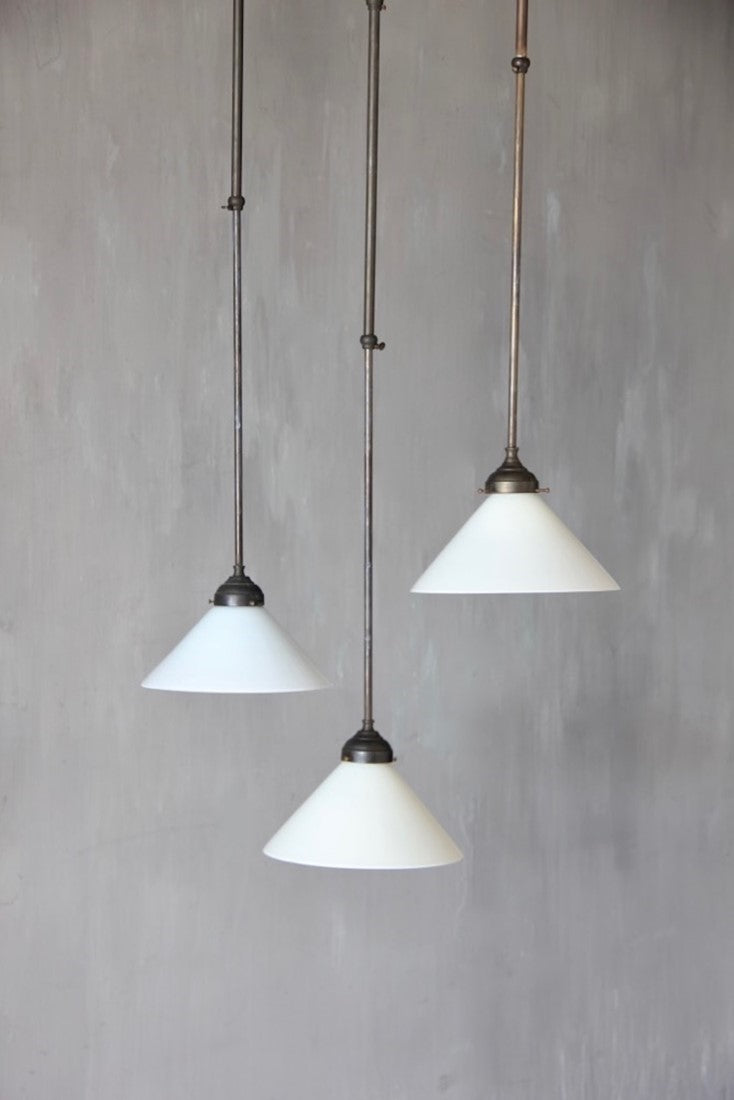 A set of 3 adjustable milk glass pendant lights