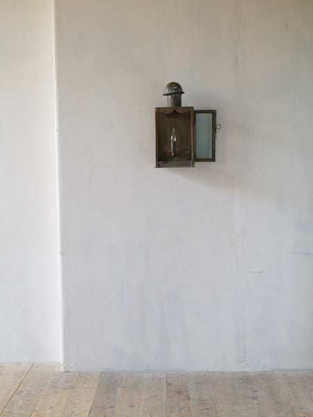A primitive copper wall lantern