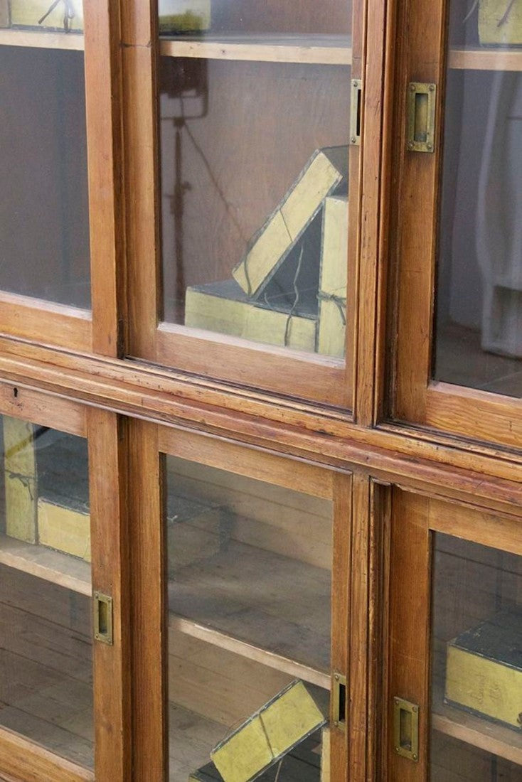 A C19th glazed pine cabinet