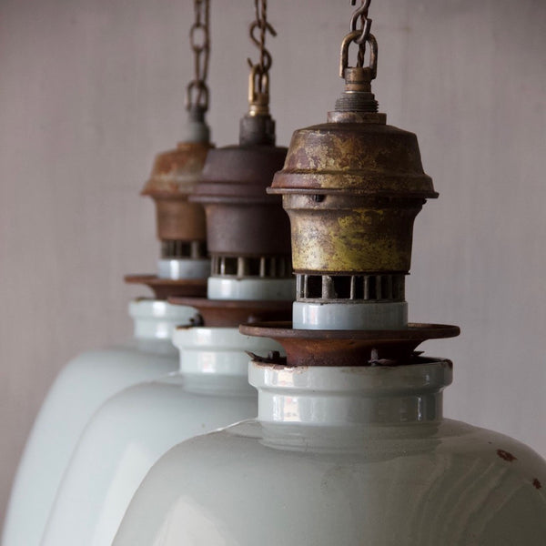 A set of three large enamelled pendant lights