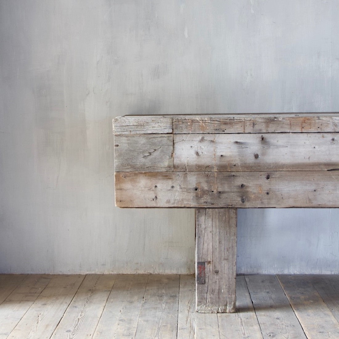 A large weathered work table