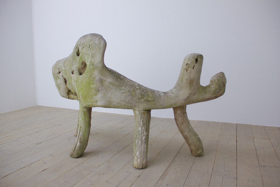 A sculptural teak bench