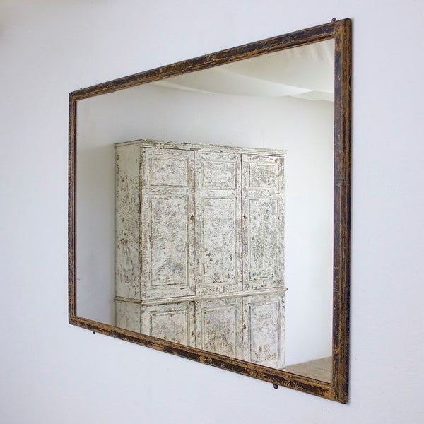 A mid c19th ebonised shop mirror
