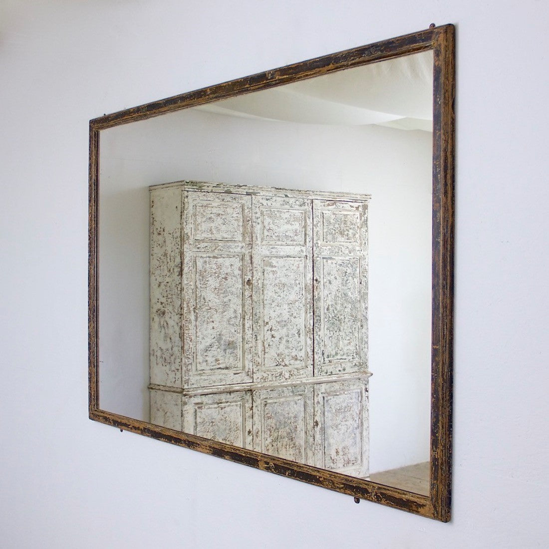 A mid c19th ebonised shop mirror