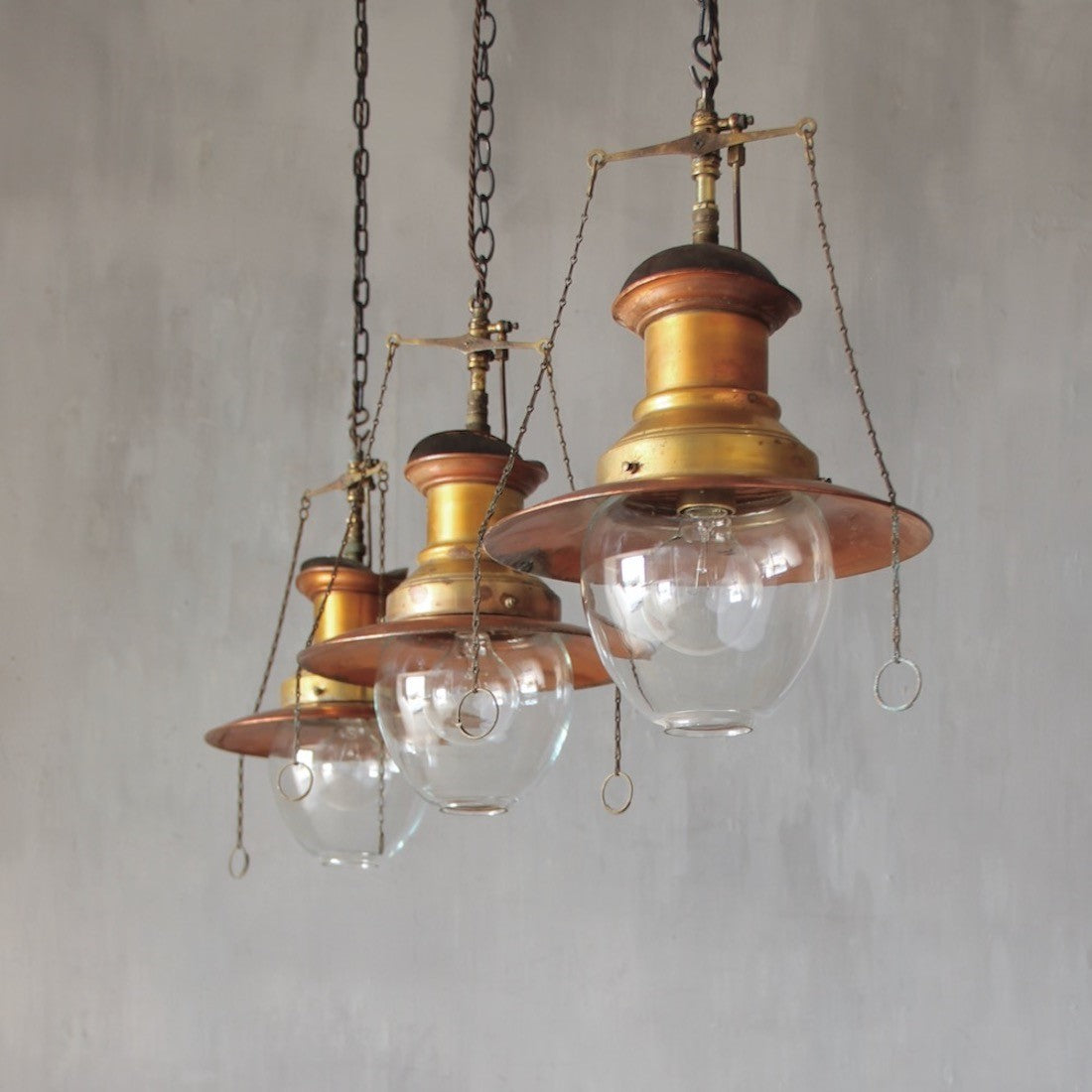 A set of three original gas pendant lights