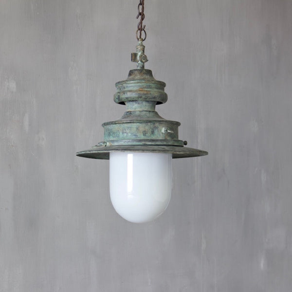 A verdigris copper station light