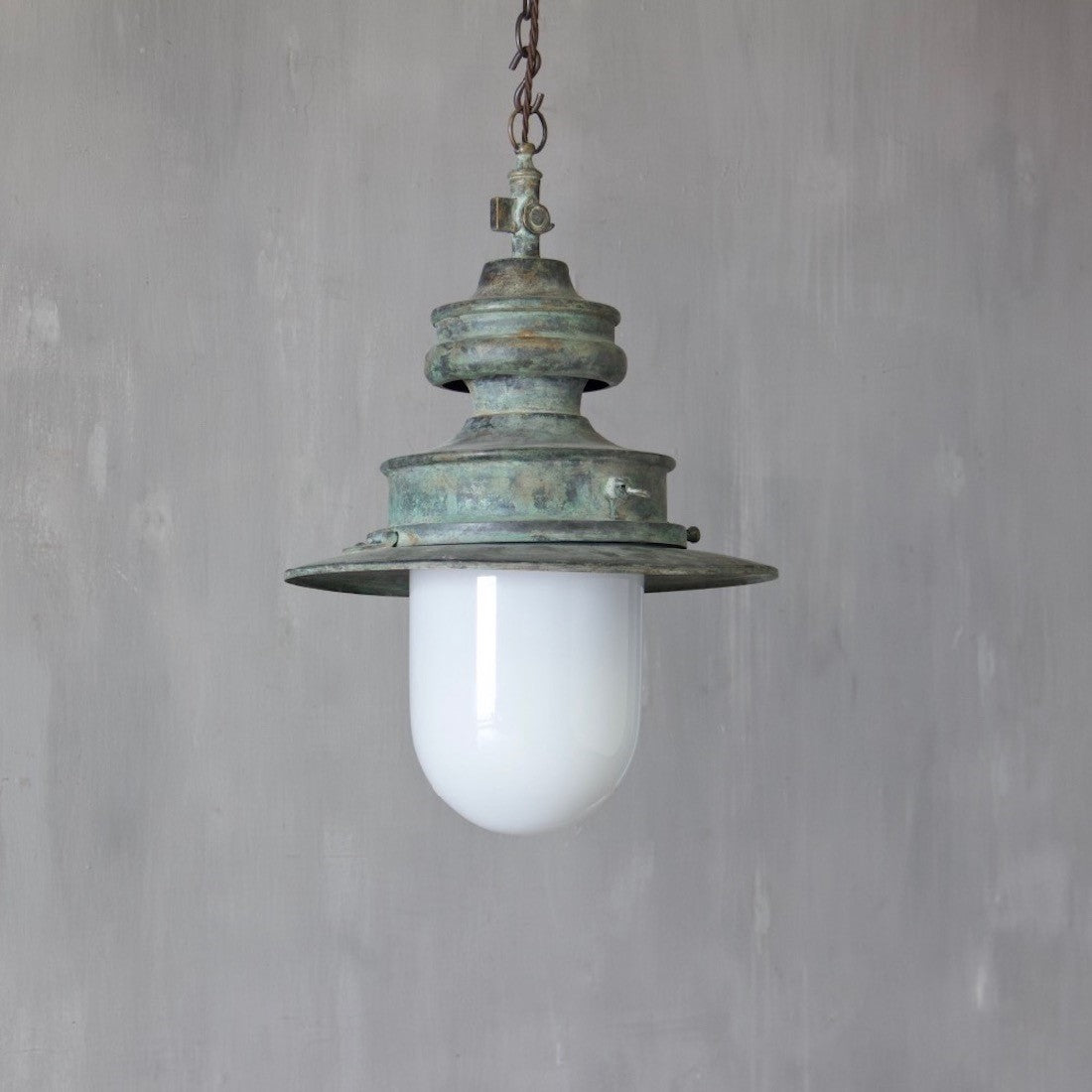 A verdigris copper station light