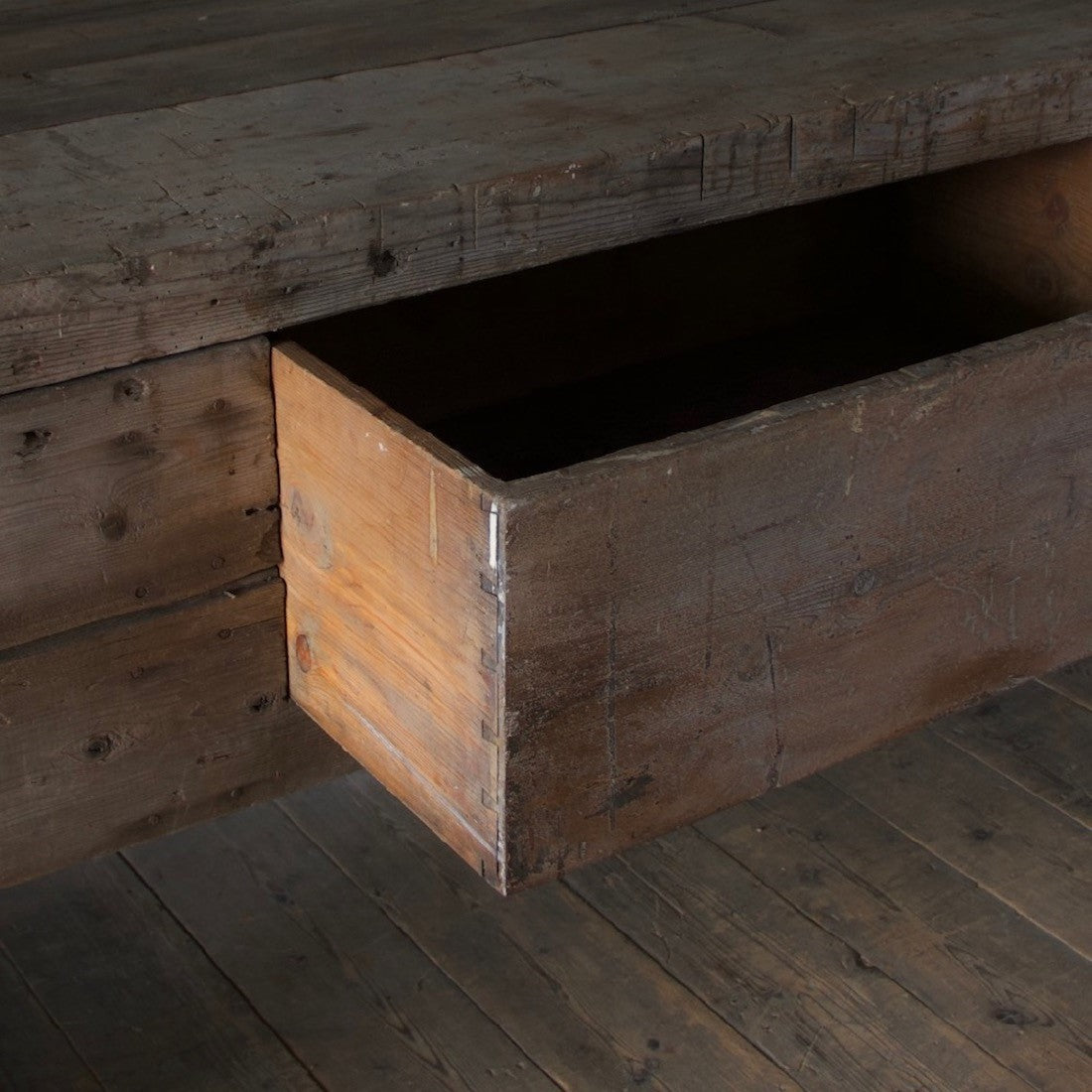A large weathered work table