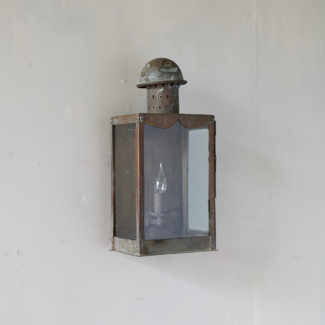 A primitive copper wall lantern