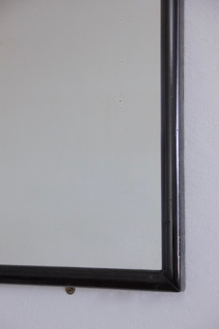 A large ebonised shop mirror
