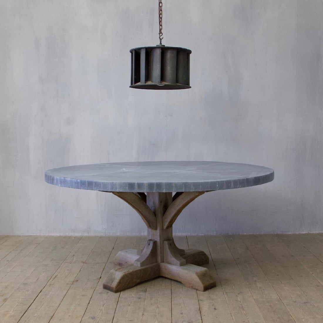 A weathered oak and zinc dining table