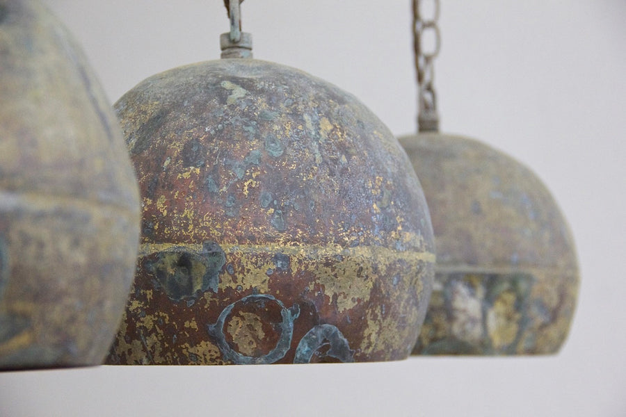 A set of three copper pendant lights