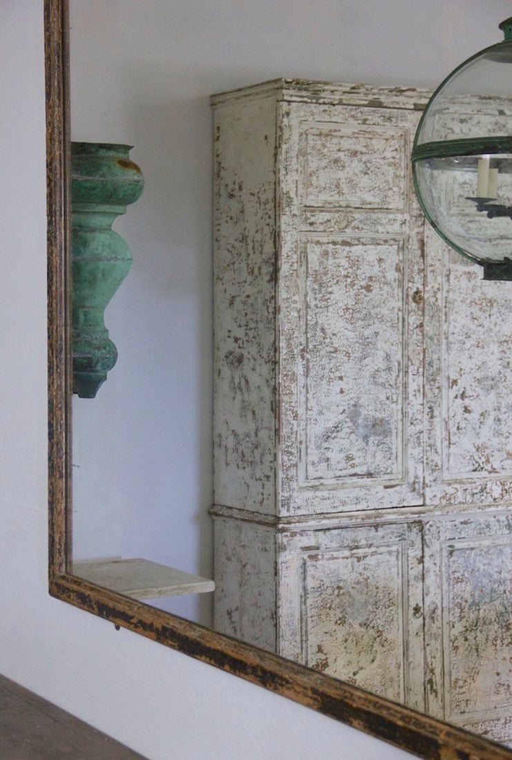 A mid c19th ebonised shop mirror