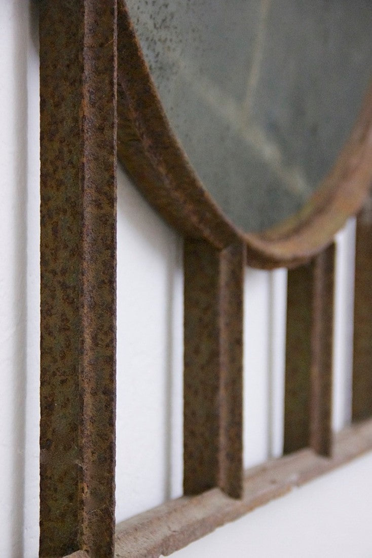A large C19th wrought iron convex mirror