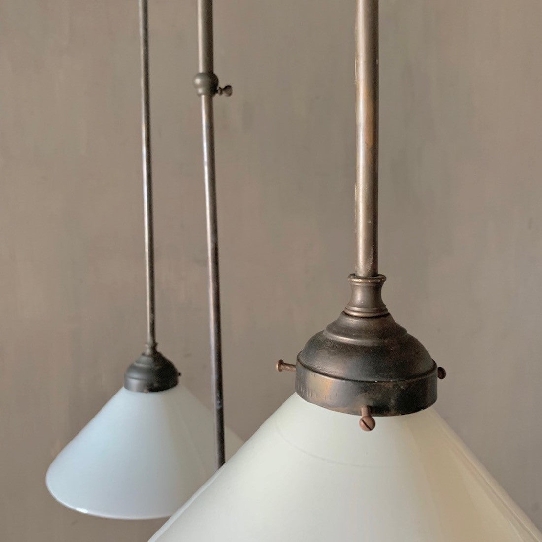 A set of 3 adjustable milk glass pendant lights