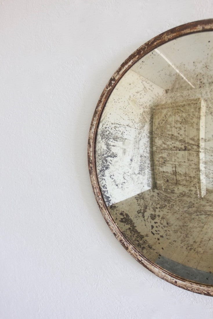 An iron-framed convex mirror