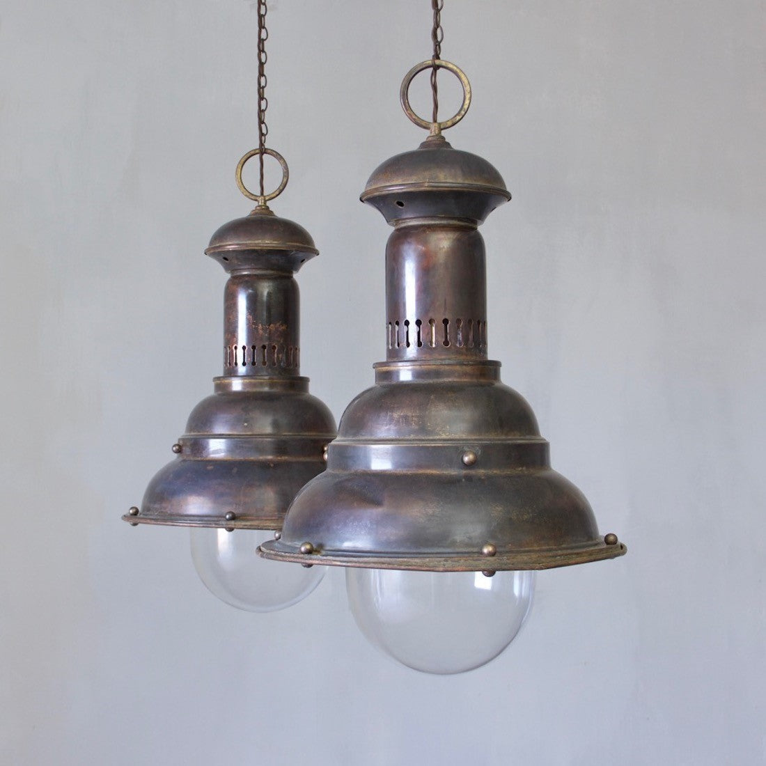 A pair of large brass pendants