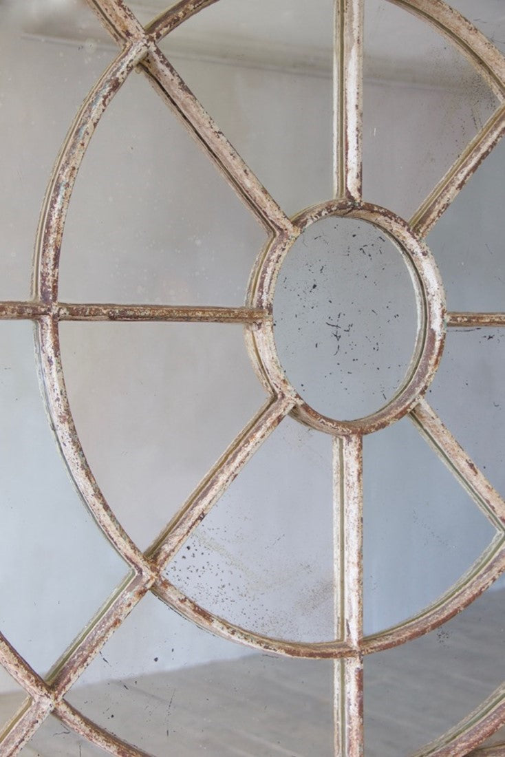 An unusual overmantle shaped cast iron window mirror