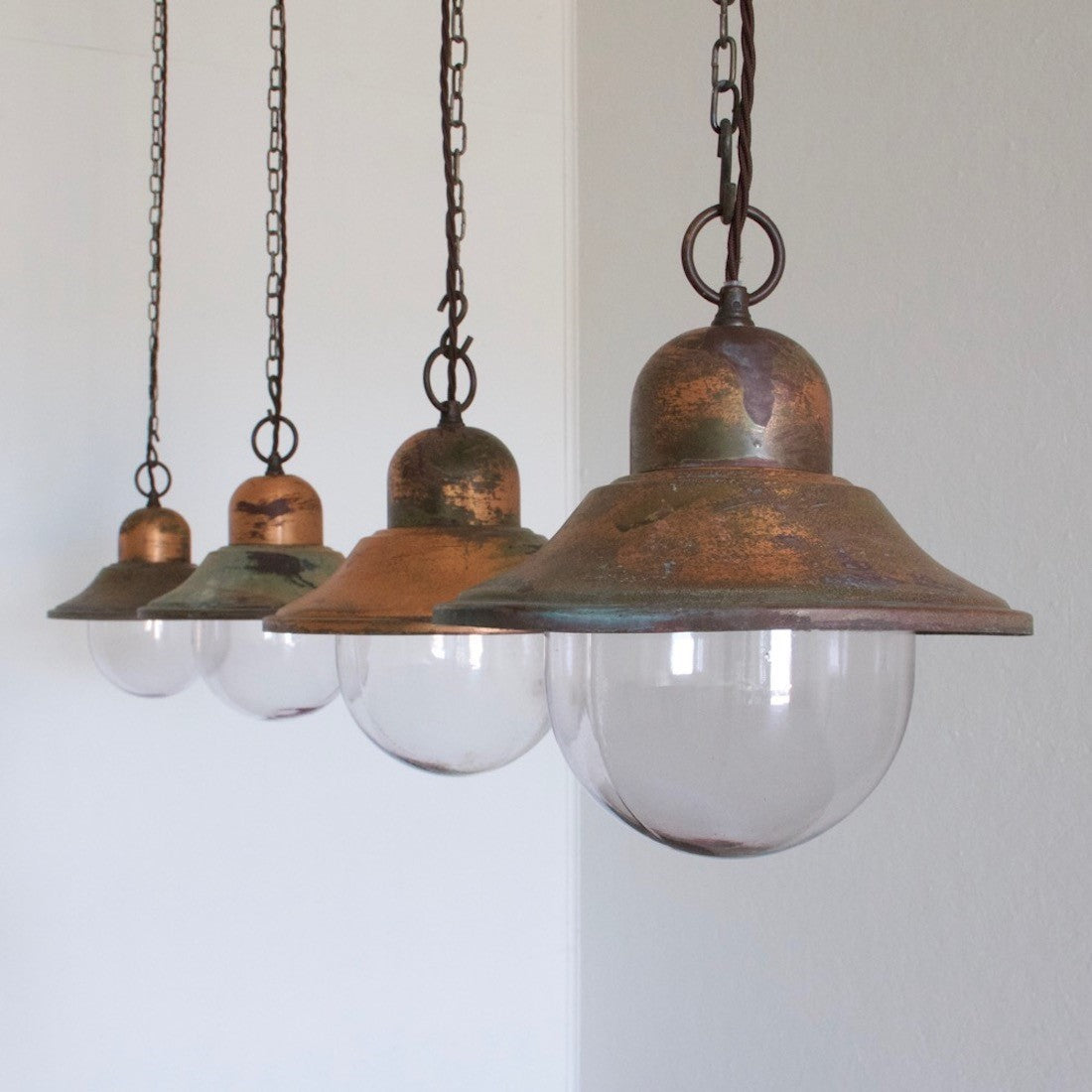 A set of 5 copper pendant lights