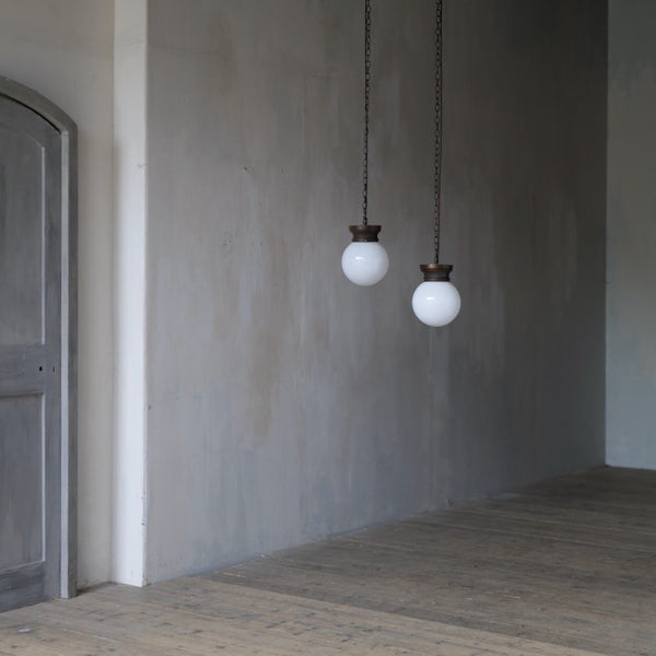 A pair of globe pendant lights