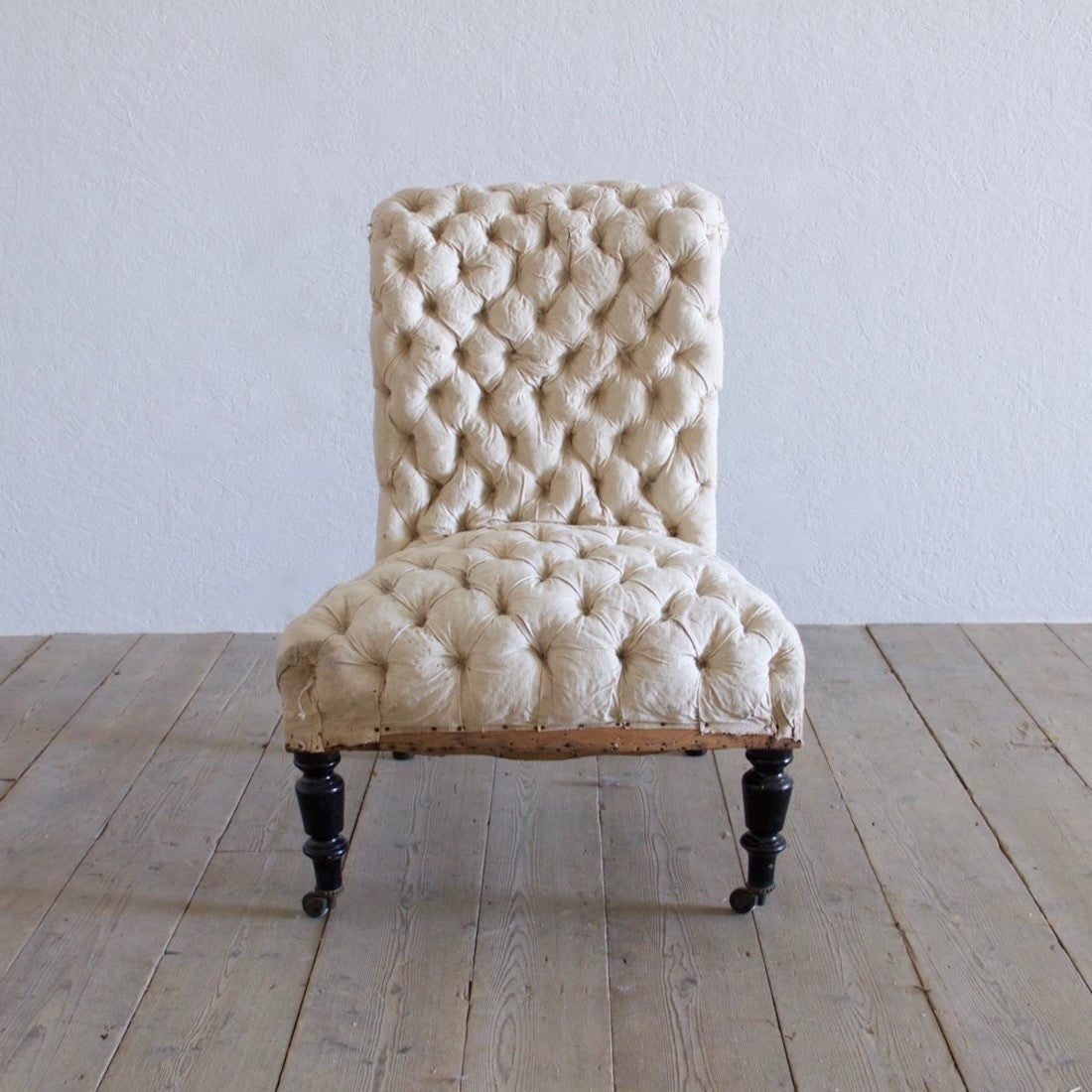 A buttoned slipper chair