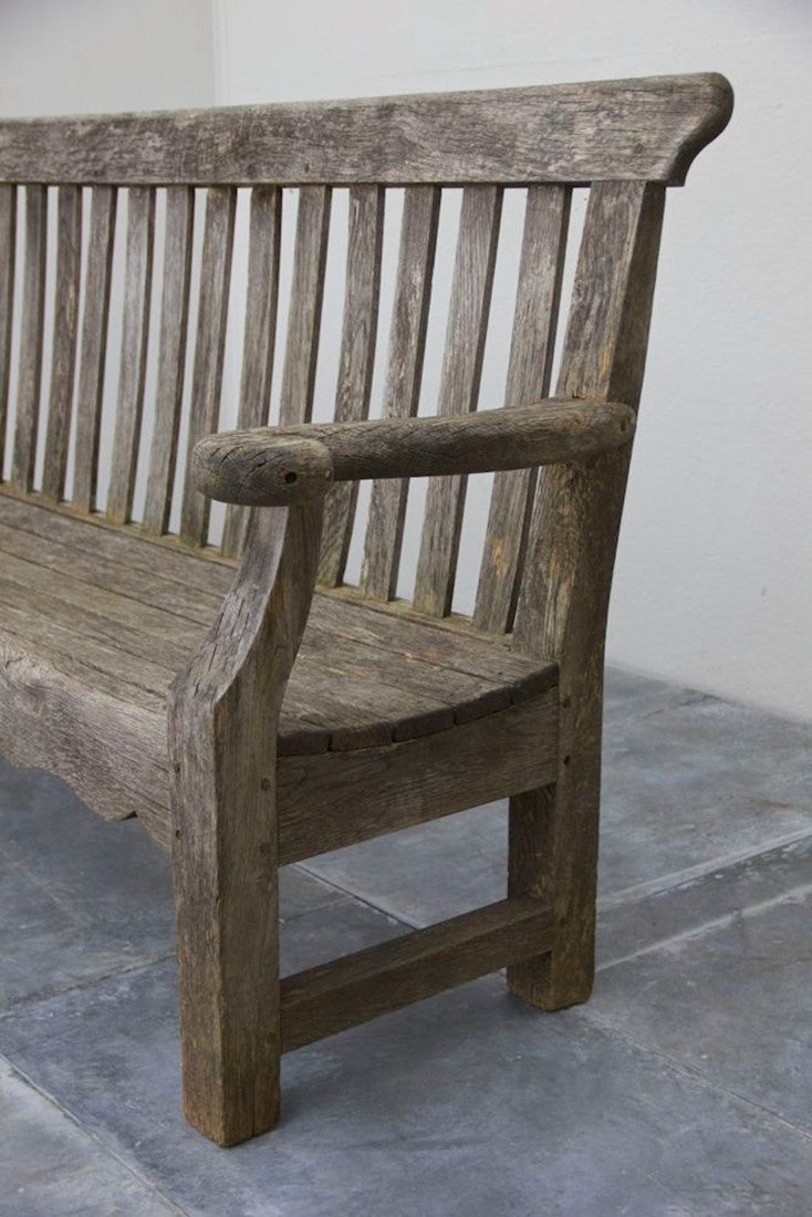 A 1920s English oak garden bench