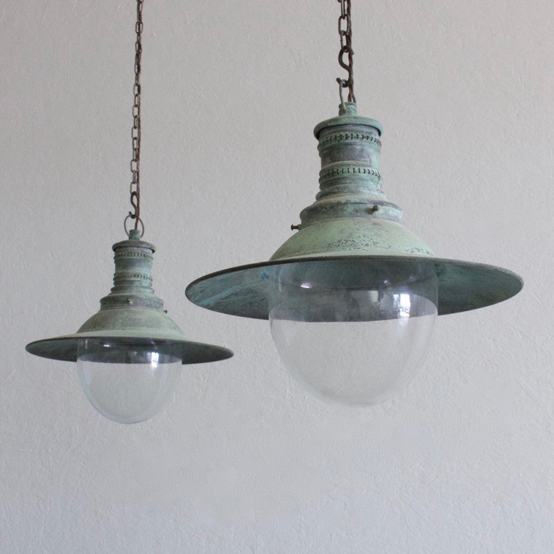 A pair of verdigris copper pendant lights