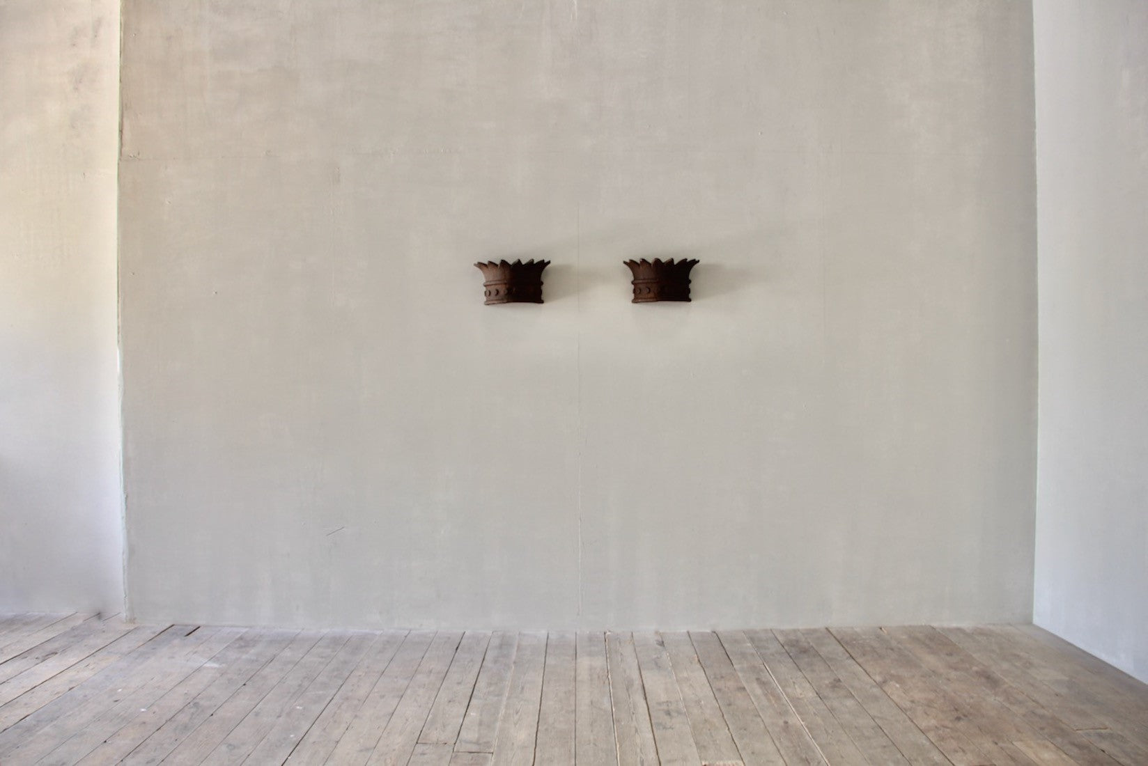 A pair of crown wall lights