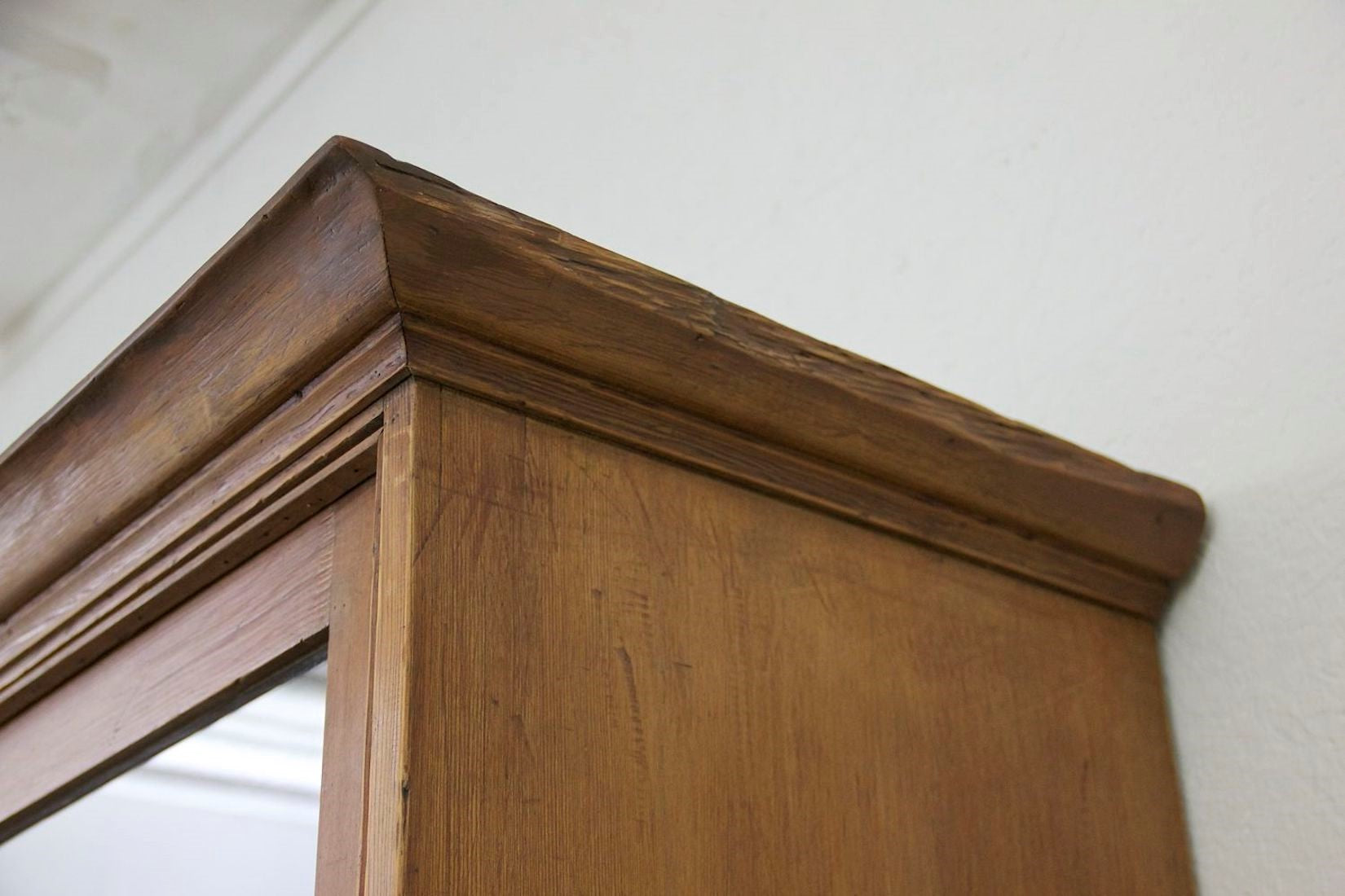 A C19th glazed pine cabinet