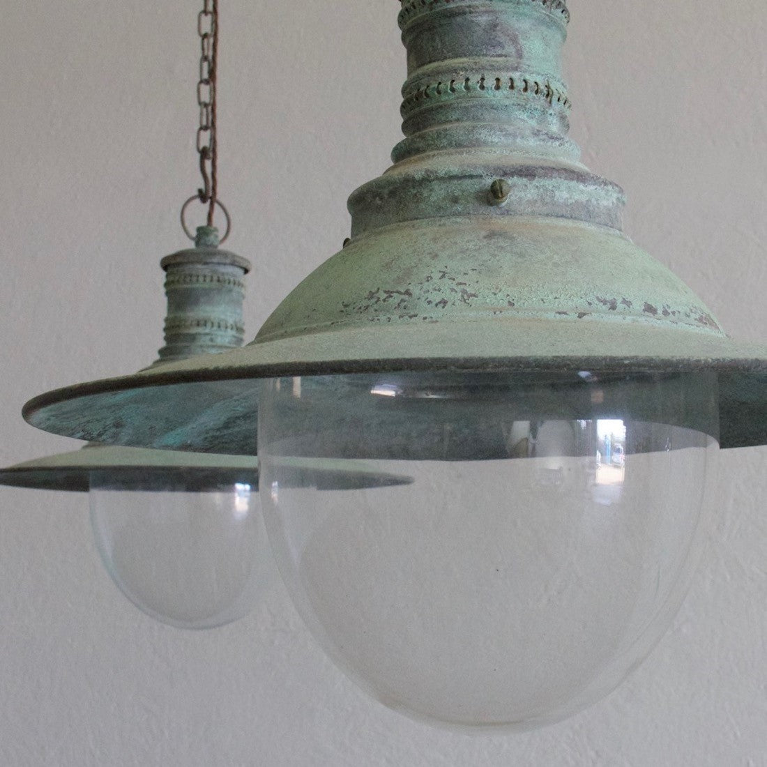 A pair of verdigris copper pendant lights