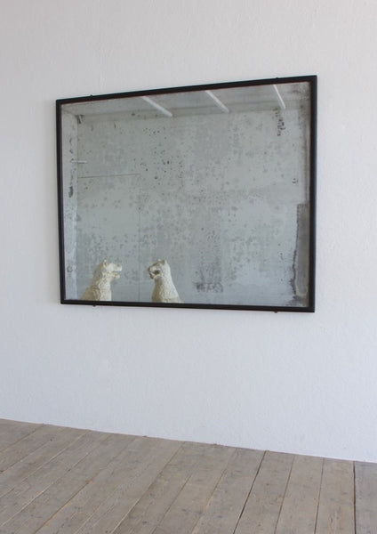 An ebonised shop mirror