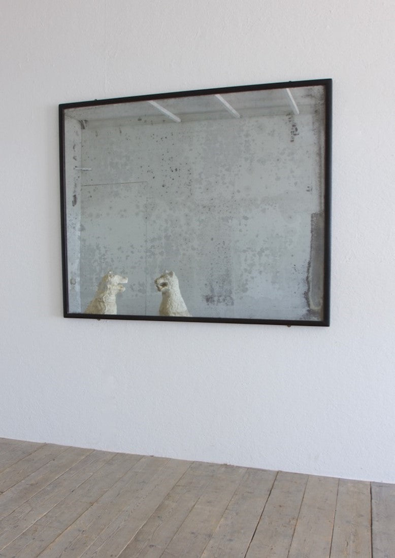 An ebonised shop mirror