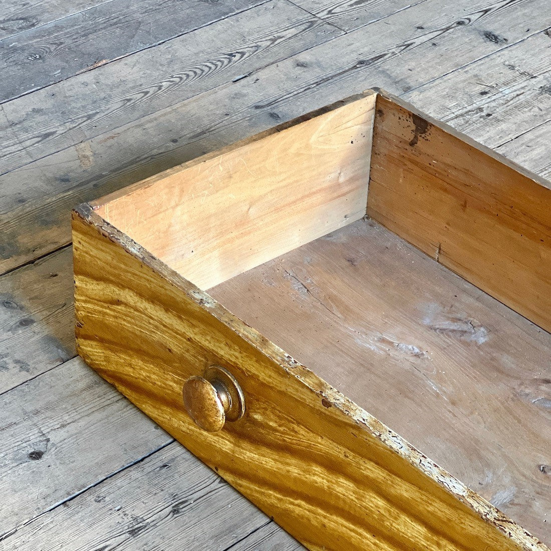 A faux elm painted chest of drawers