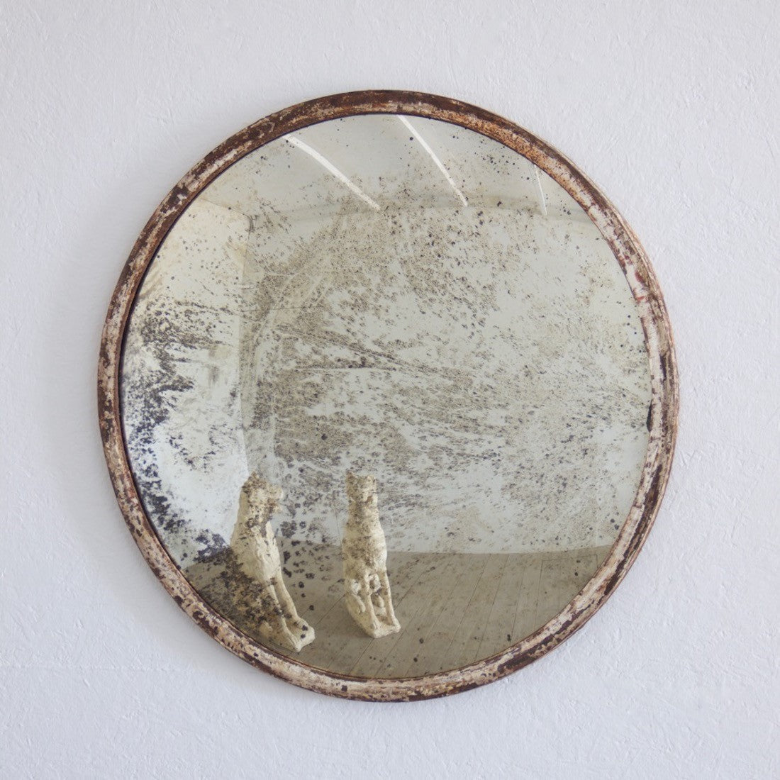 An iron-framed convex mirror