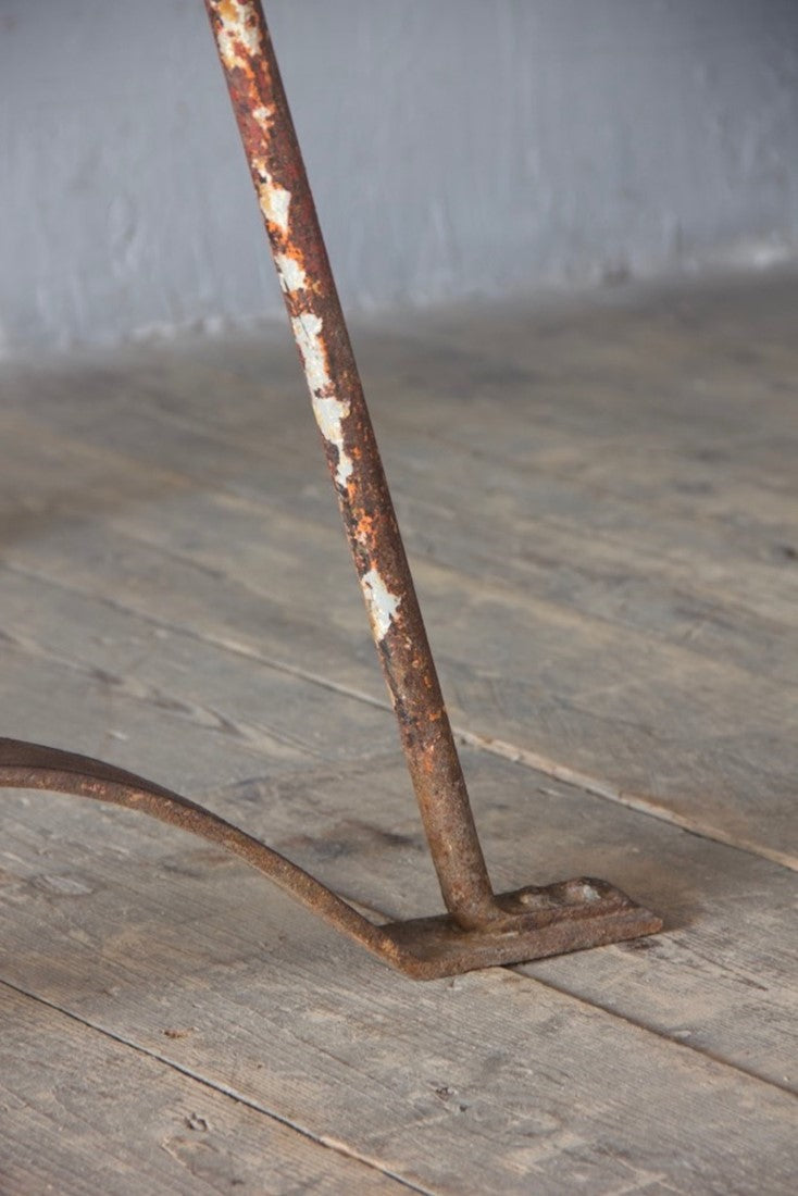 An architectural wrought iron trestle table