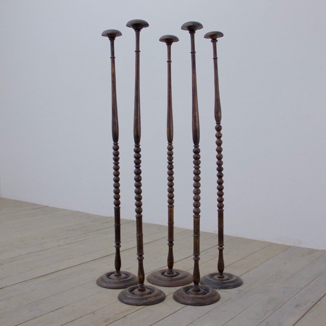 A collection of 5 ebonised hat stands