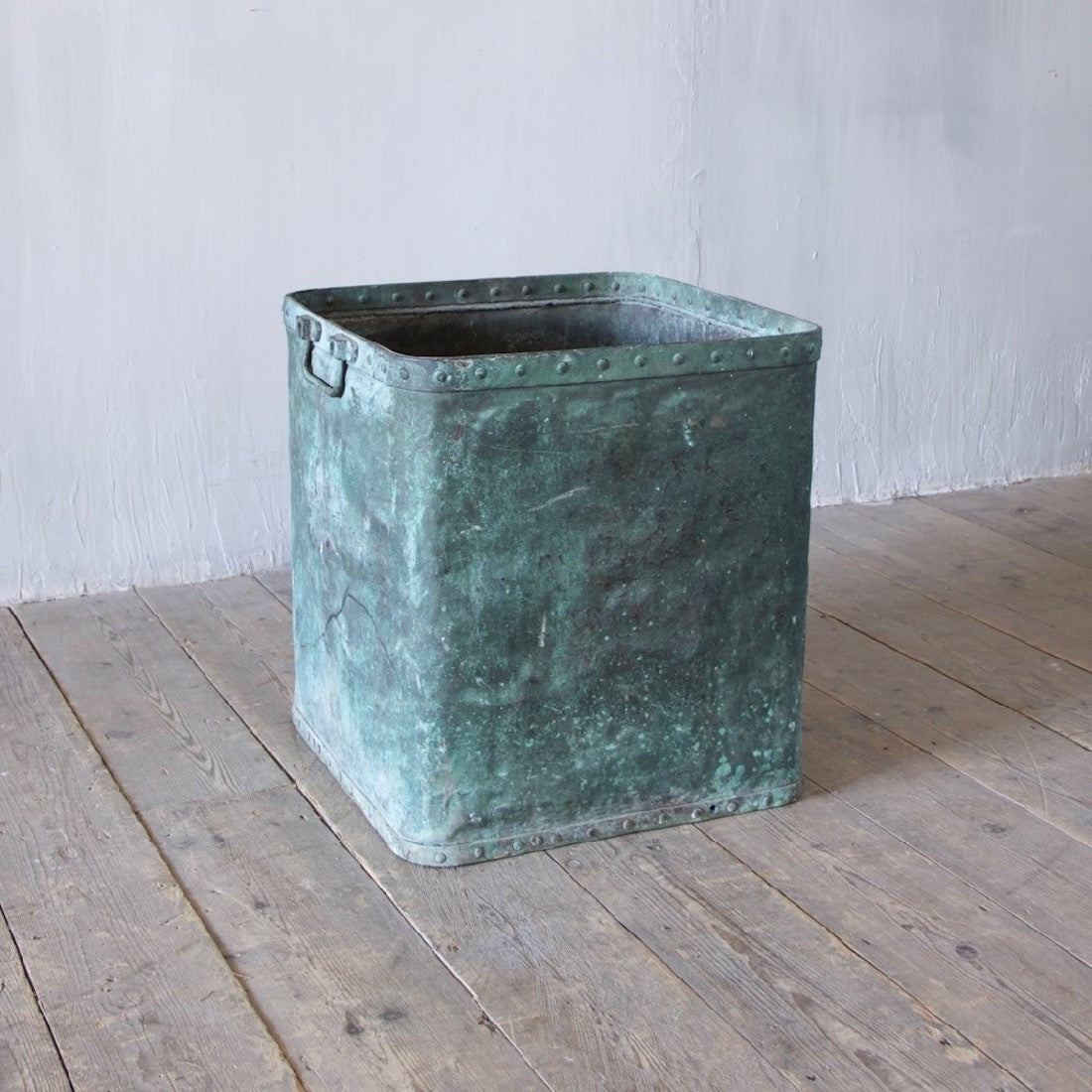 A verdigris copper tub