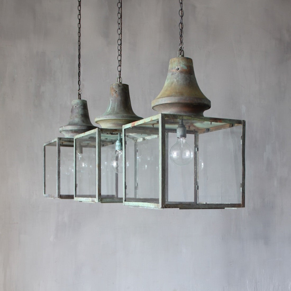 A set of three verdigris copper lanterns