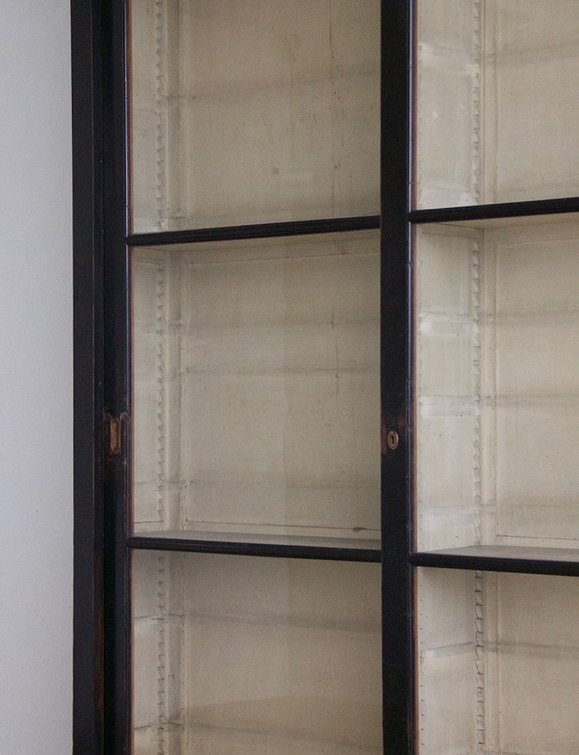 An ebonised sliding door cabinet