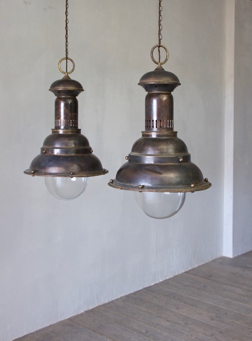 A pair of large brass pendants