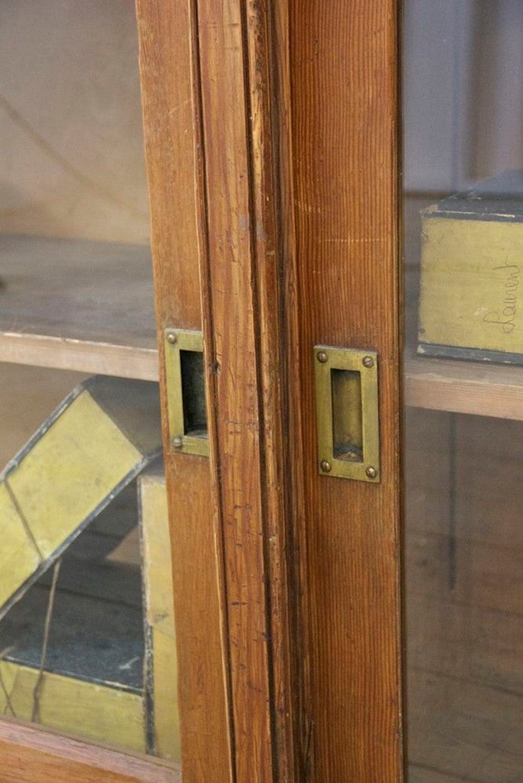 A C19th glazed pine cabinet