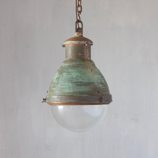 An industrial copper pendant light