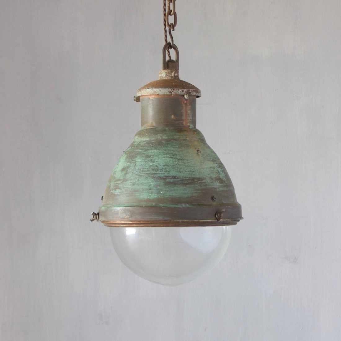 An industrial copper pendant light