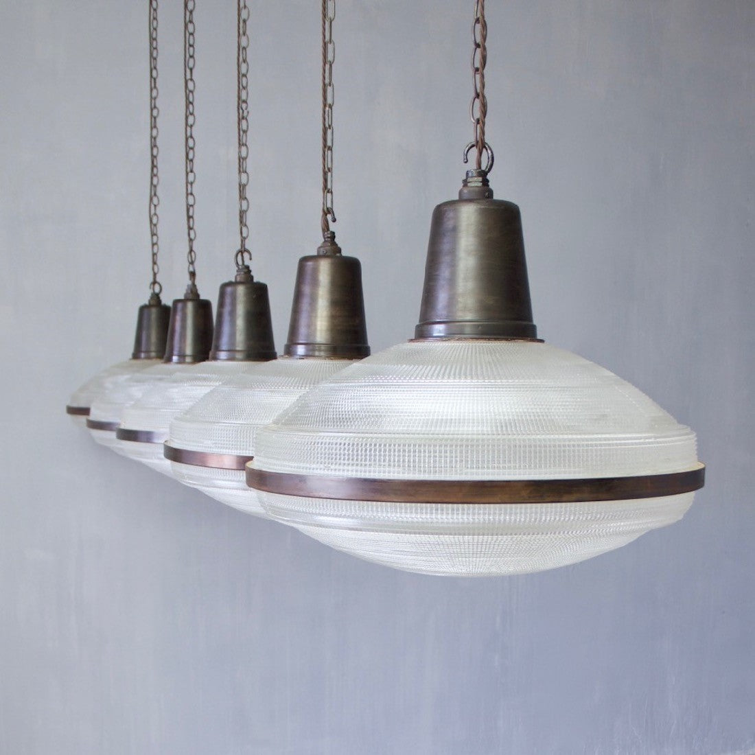 A set of 5 large Holophane pendant lights